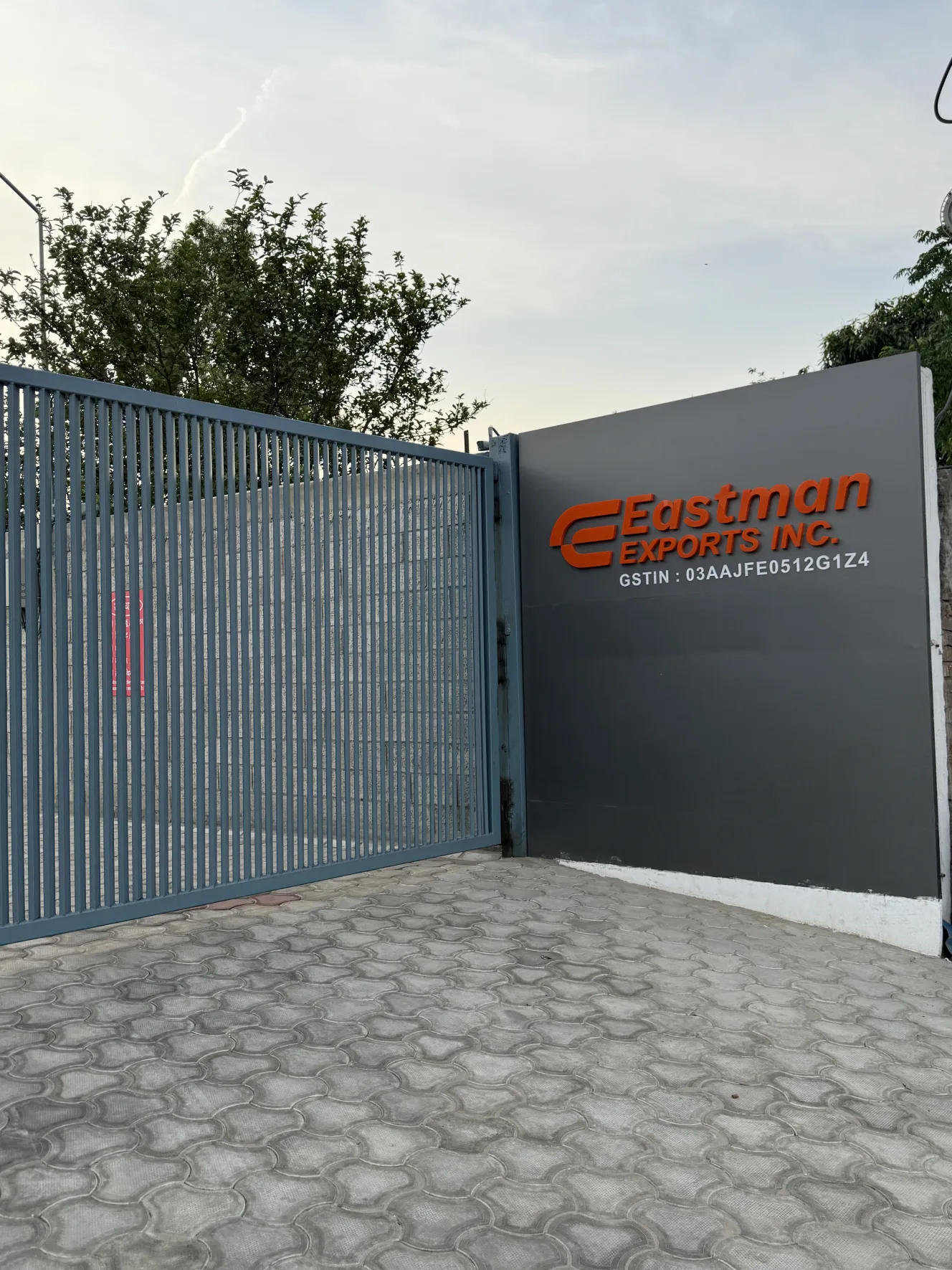 Eastman Exports company gate with modern steel fencing and signage, leading scaffolding and construction supplier